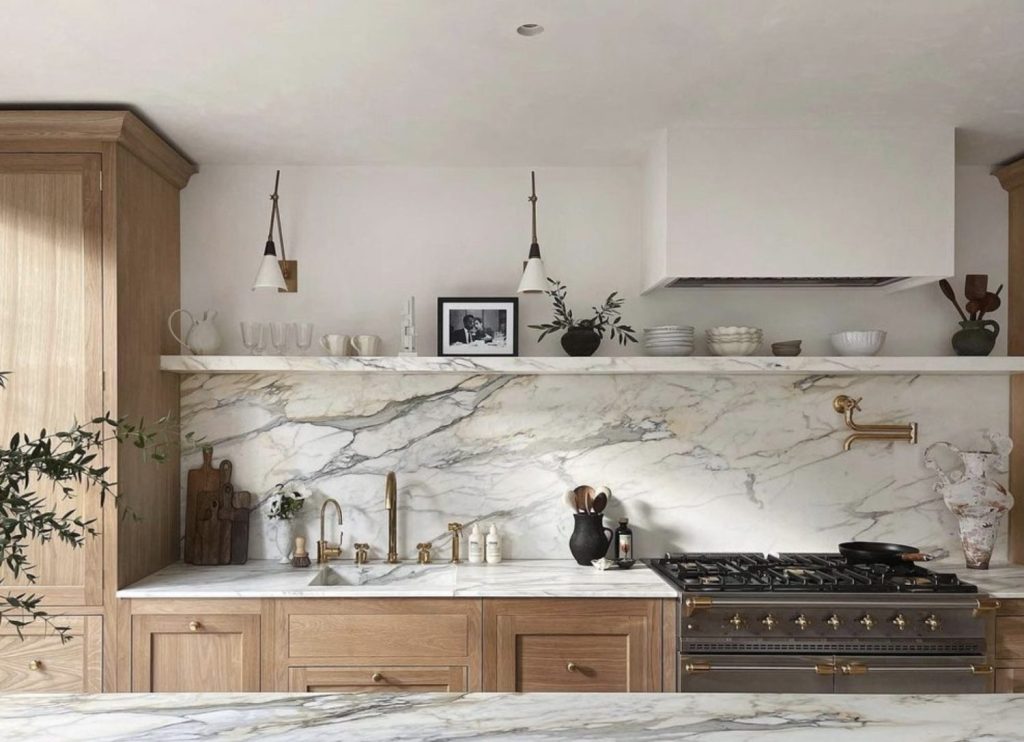Beautiful kitchen with light wood cabinets, marble counters, backslapsh and minimal decor