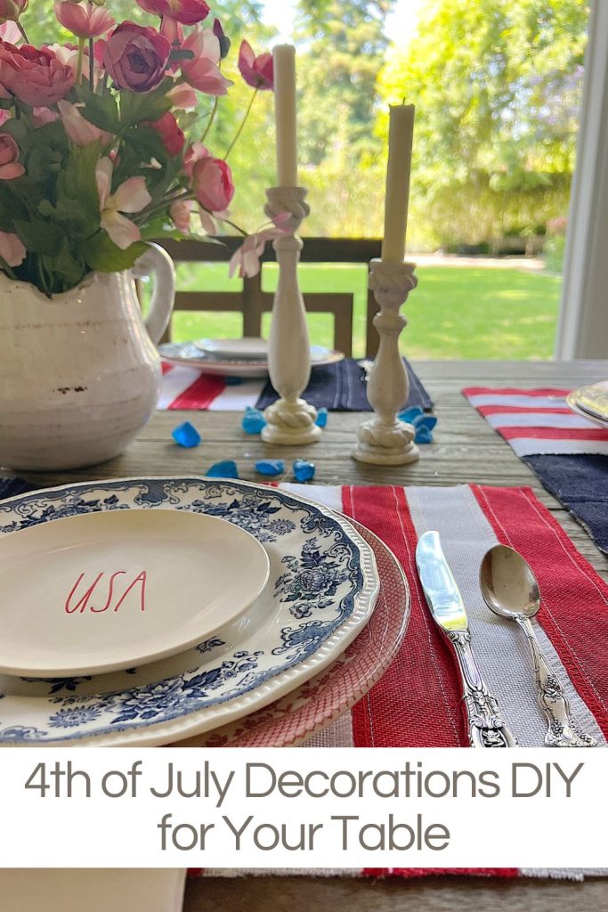 A 4th of July themed table with DIY flag placemats, red and blue and white plates, USA salad plates and candlesticks.
