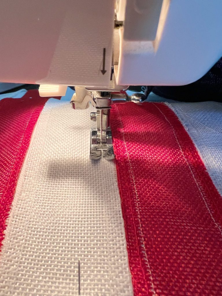 Sewing the burlap on to the white cotton placemat.