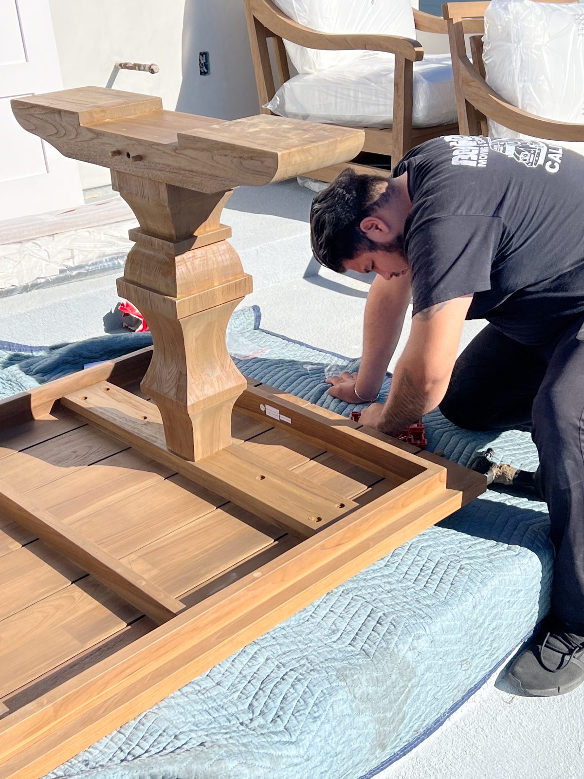The deck on our third floor with Arhaus furniture, a fire pit, and dinner decor items.