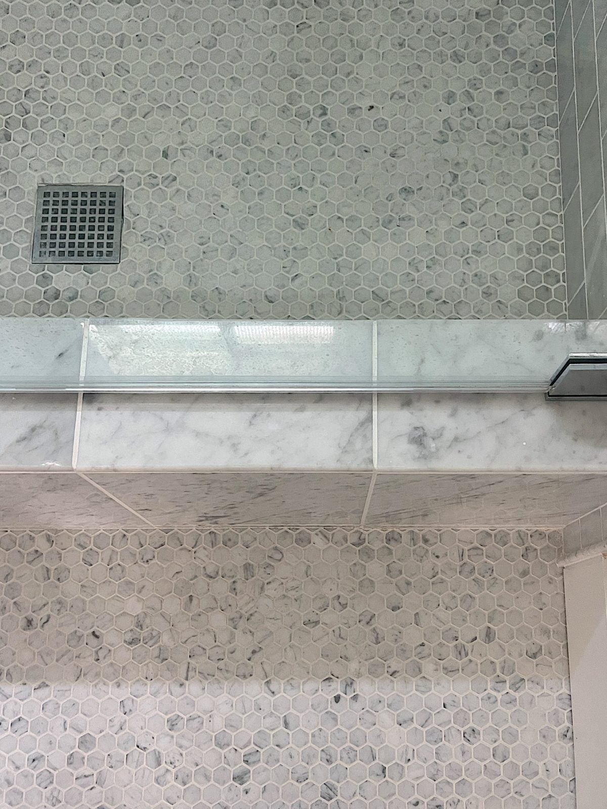 A newly constructed en suite bathroom with a step in steam shower 9with tub), single marble vanity and decor.