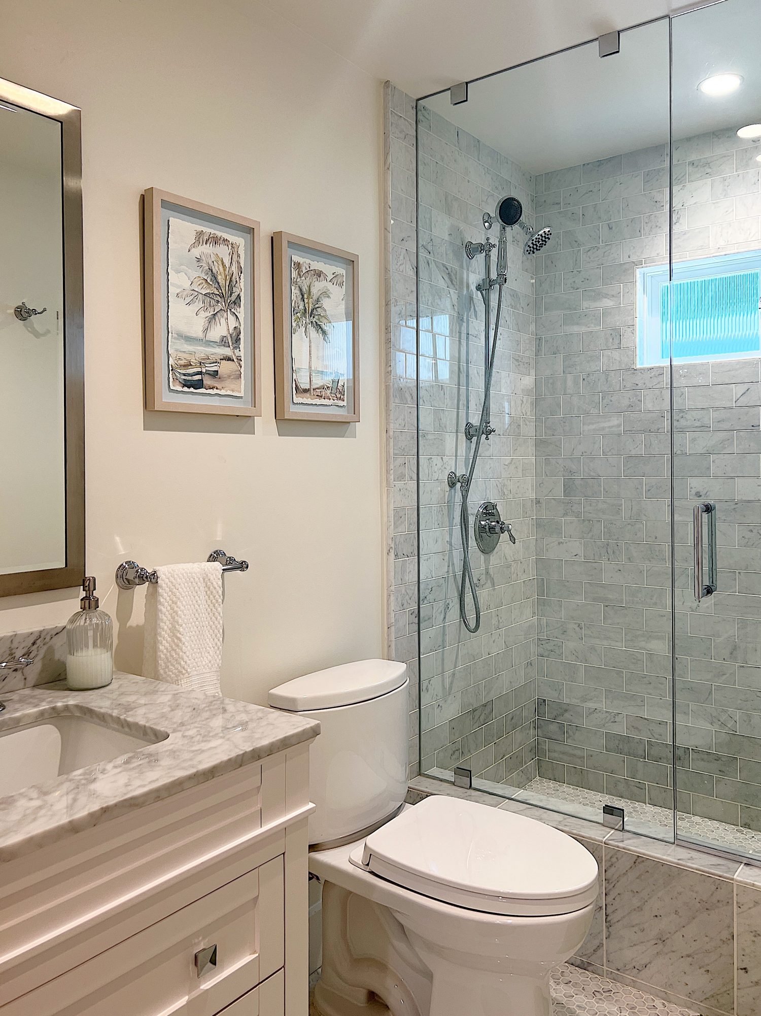 A newly constructed en suite bathroom with a step in steam shower 9with tub), single marble vanity and decor.