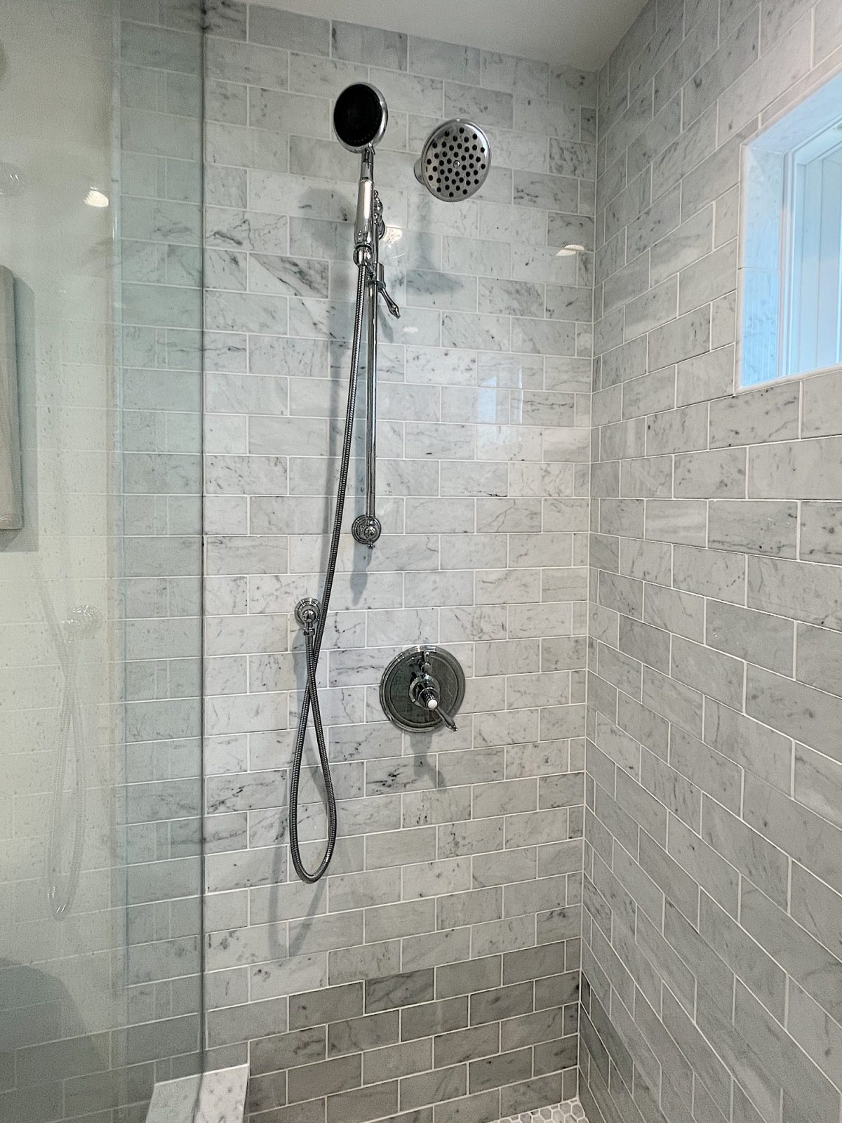 A newly constructed en suite bathroom with a step in steam shower 9with tub), single marble vanity and decor.