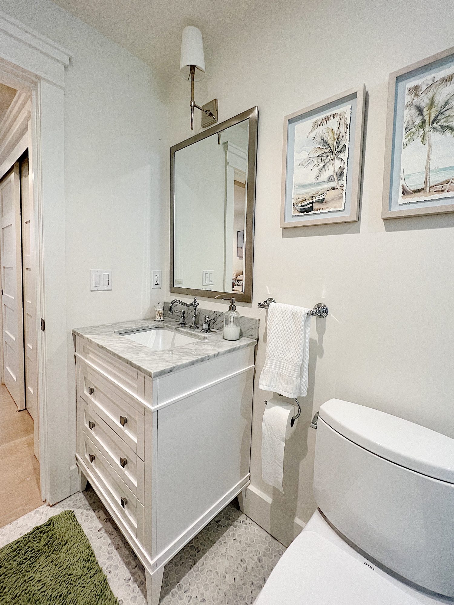 A newly constructed en suite bathroom with a step in steam shower 9with tub), single marble vanity and decor.