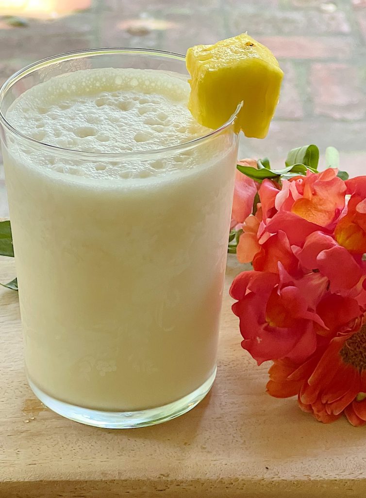 A freshly made Pina Colada Refreshing Summer Mocktail with a pineapple garnish.