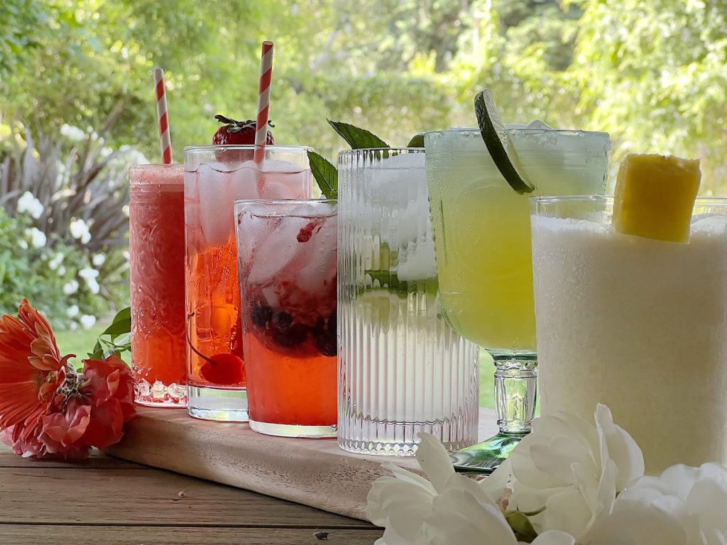Freshly made Refreshing Summer Mocktails in different glasses with a fun garnish.