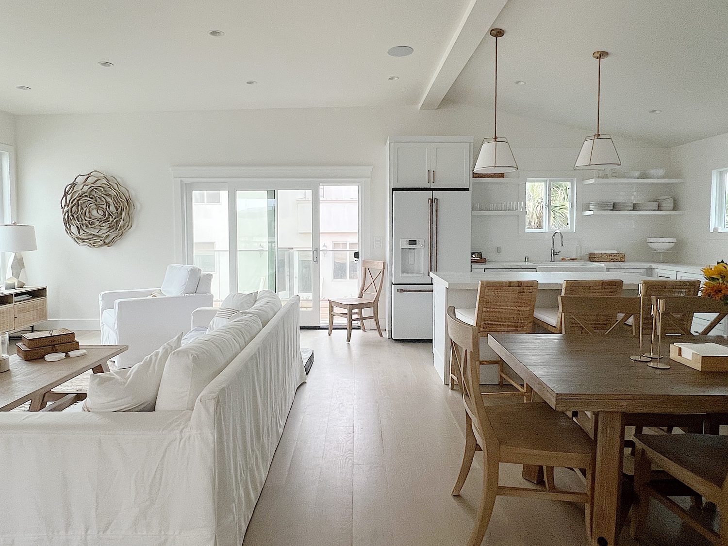 The Beach House family room styled in off-white and tan decor.