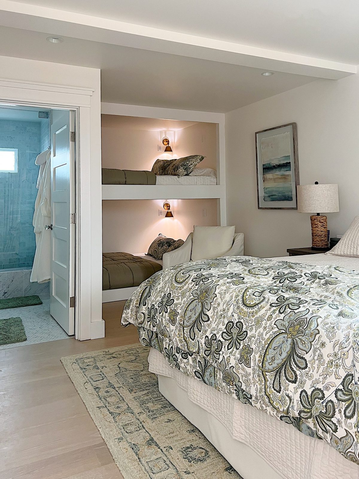 The bunk room with one king size bed with bedding and two queen-size built-in bunk beds.