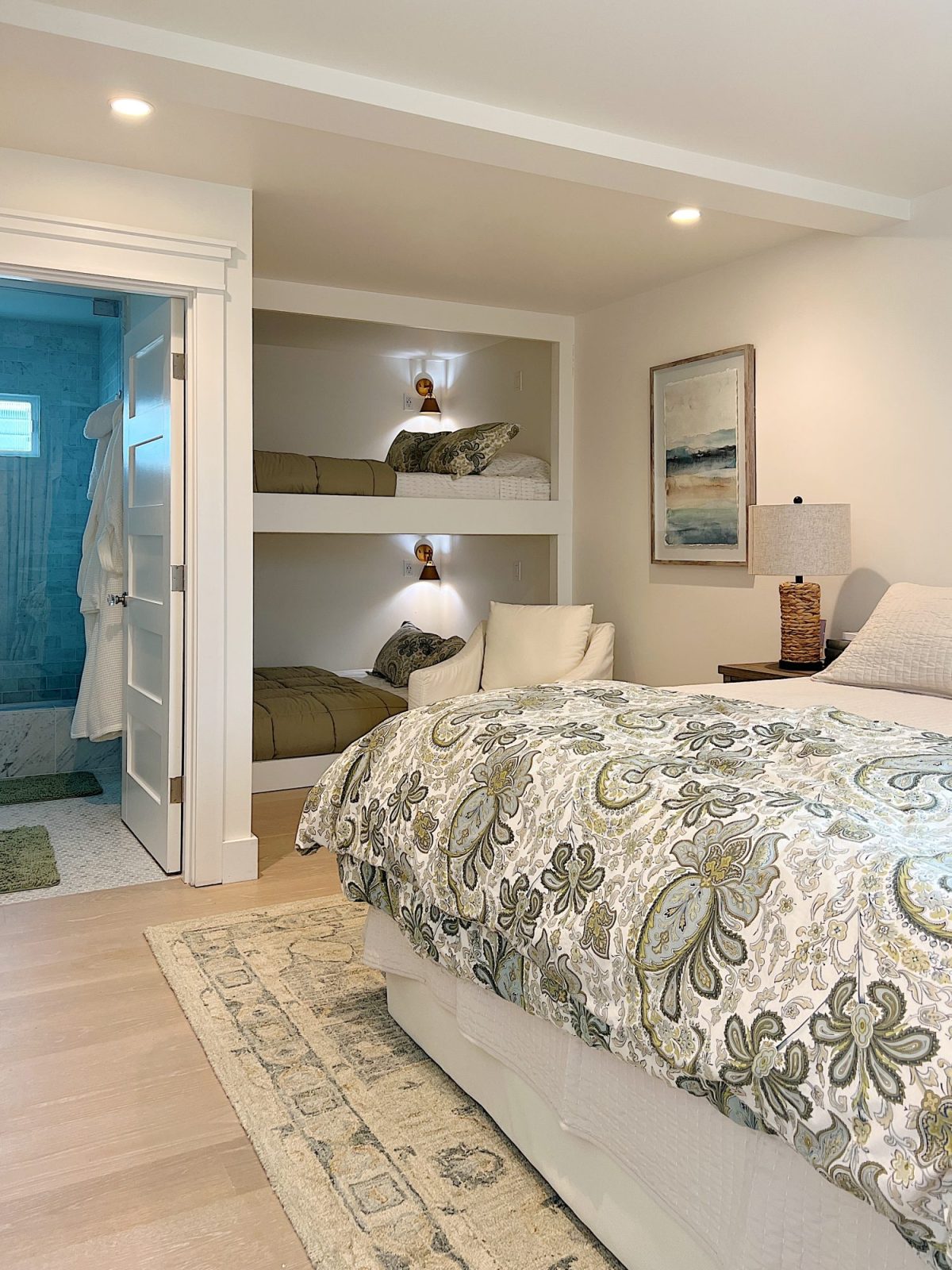 The bunk room with one king size bed with bedding and two queen-size built-in bunk beds.