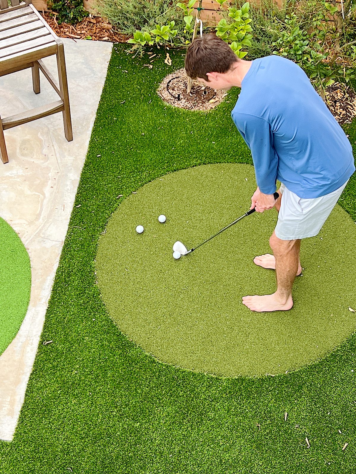 Michael chipping on our Backyard Putting Green
