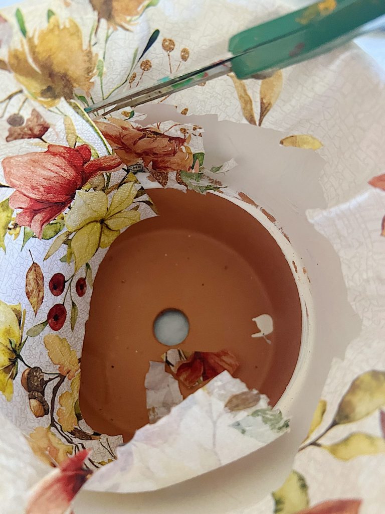 How to cover a terra cotta pot with a paper napkin.