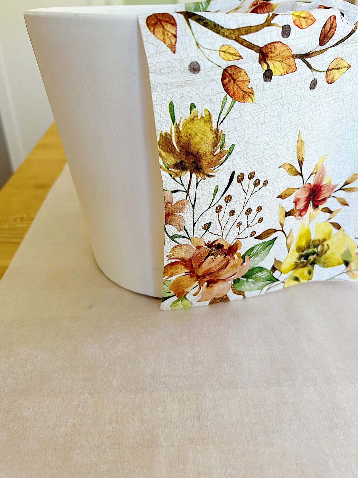 How to cover a terra cotta pot with a paper napkin.