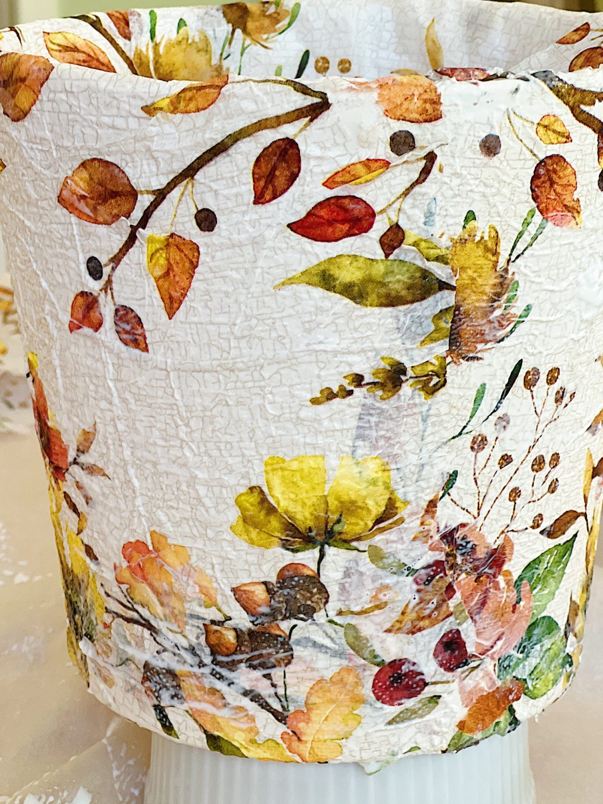 How to cover a terra cotta pot with a paper napkin.