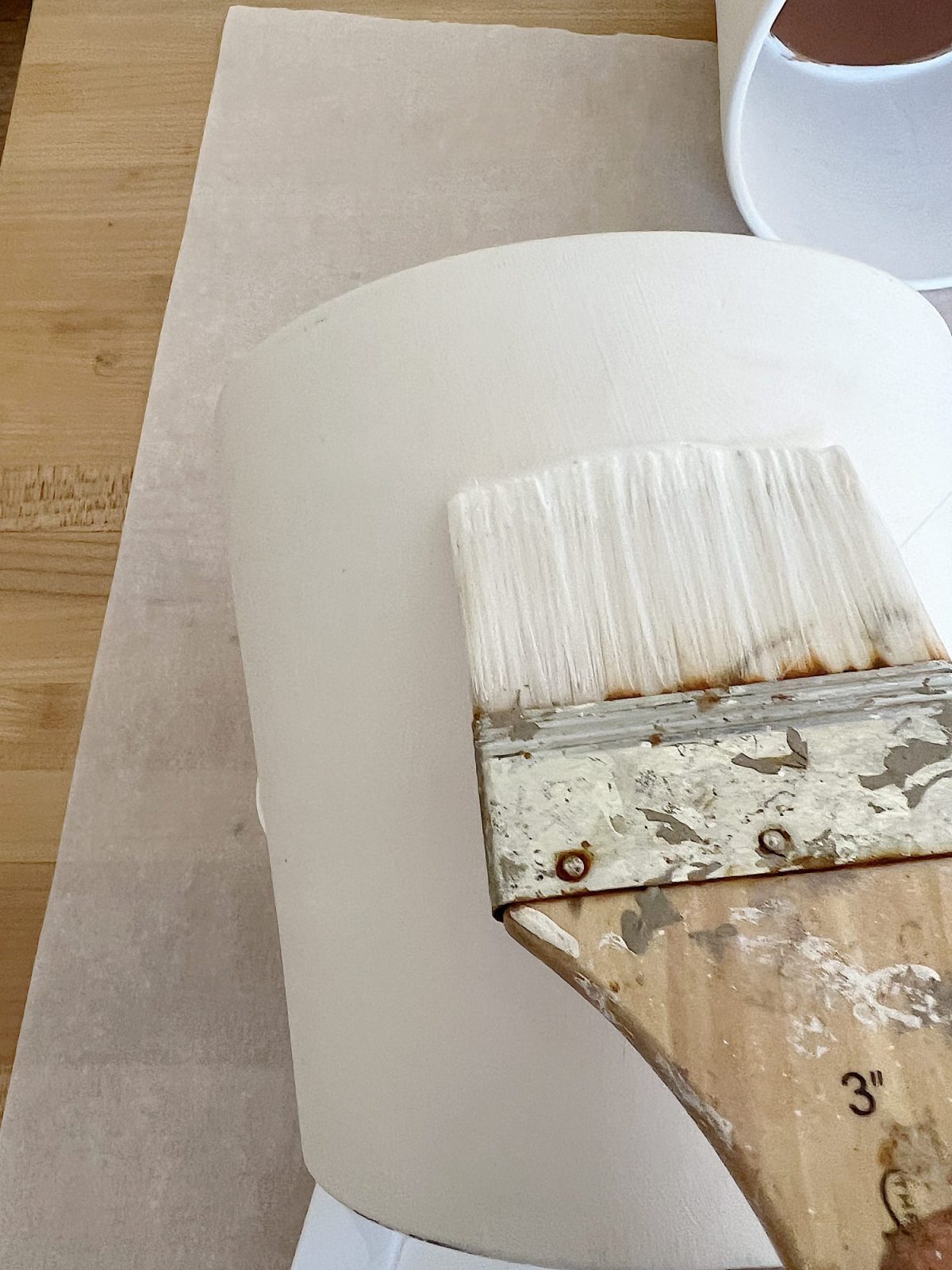 How to cover a terra cotta pot with a paper napkin.