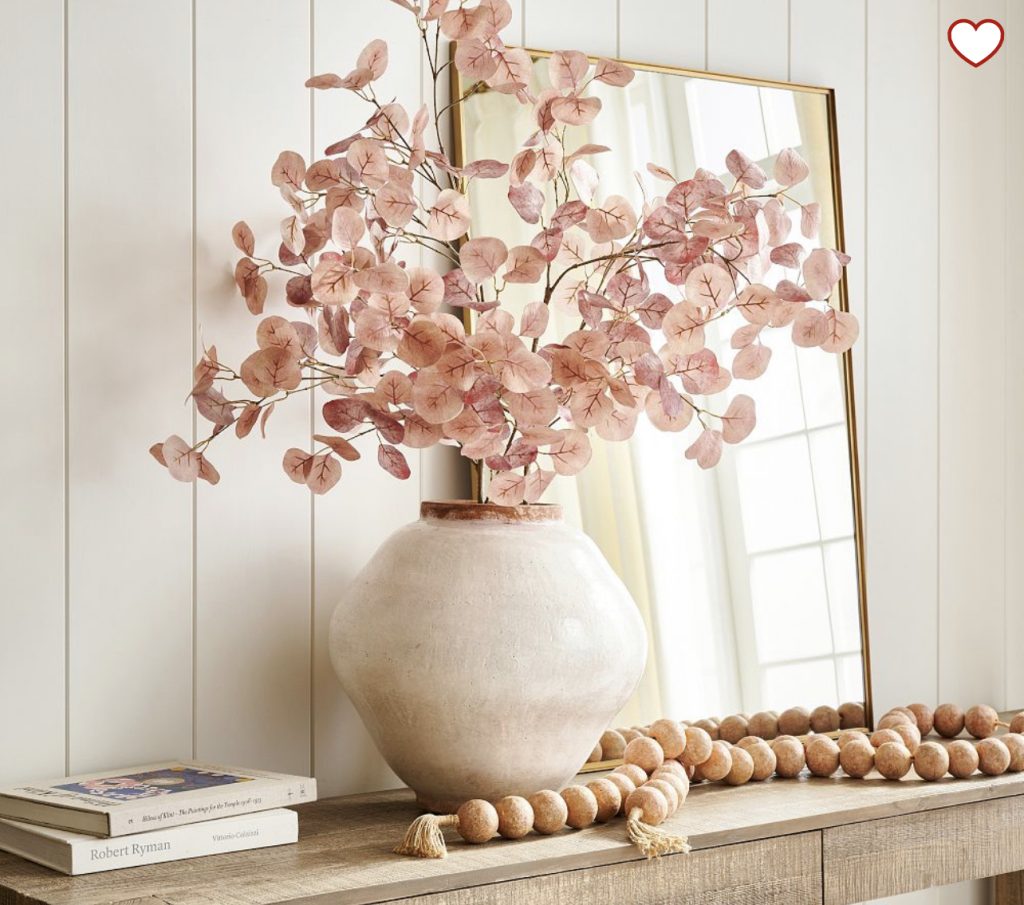 Fall home decor inspiration photos with pink eucalyptus in a white vase with wood beads.