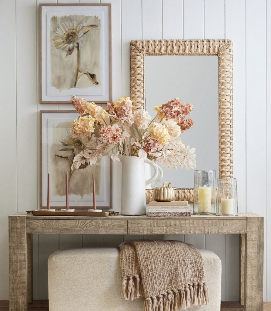 Fall home decor inspiration photos with hydrangeas, eucalyptus, a mirror, candles, a gold pumpkin and artwork.