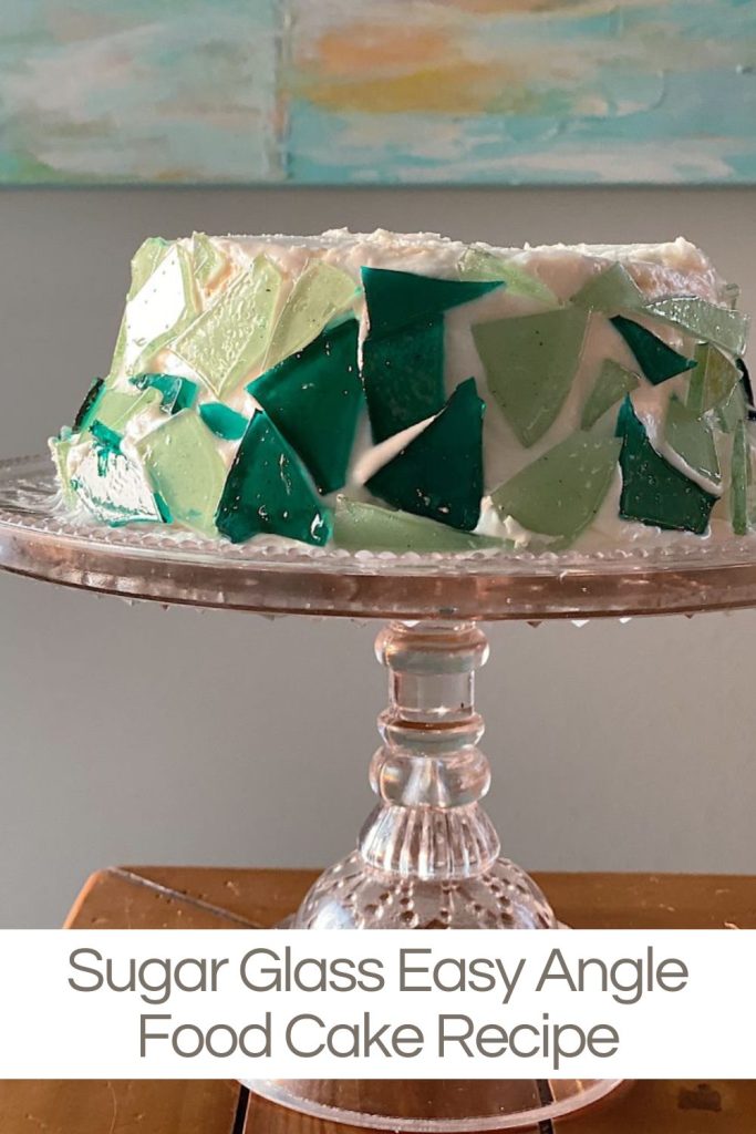 An angel food cake that looks like it was decorated with sea glass. It was actually decorated with sugar glass.