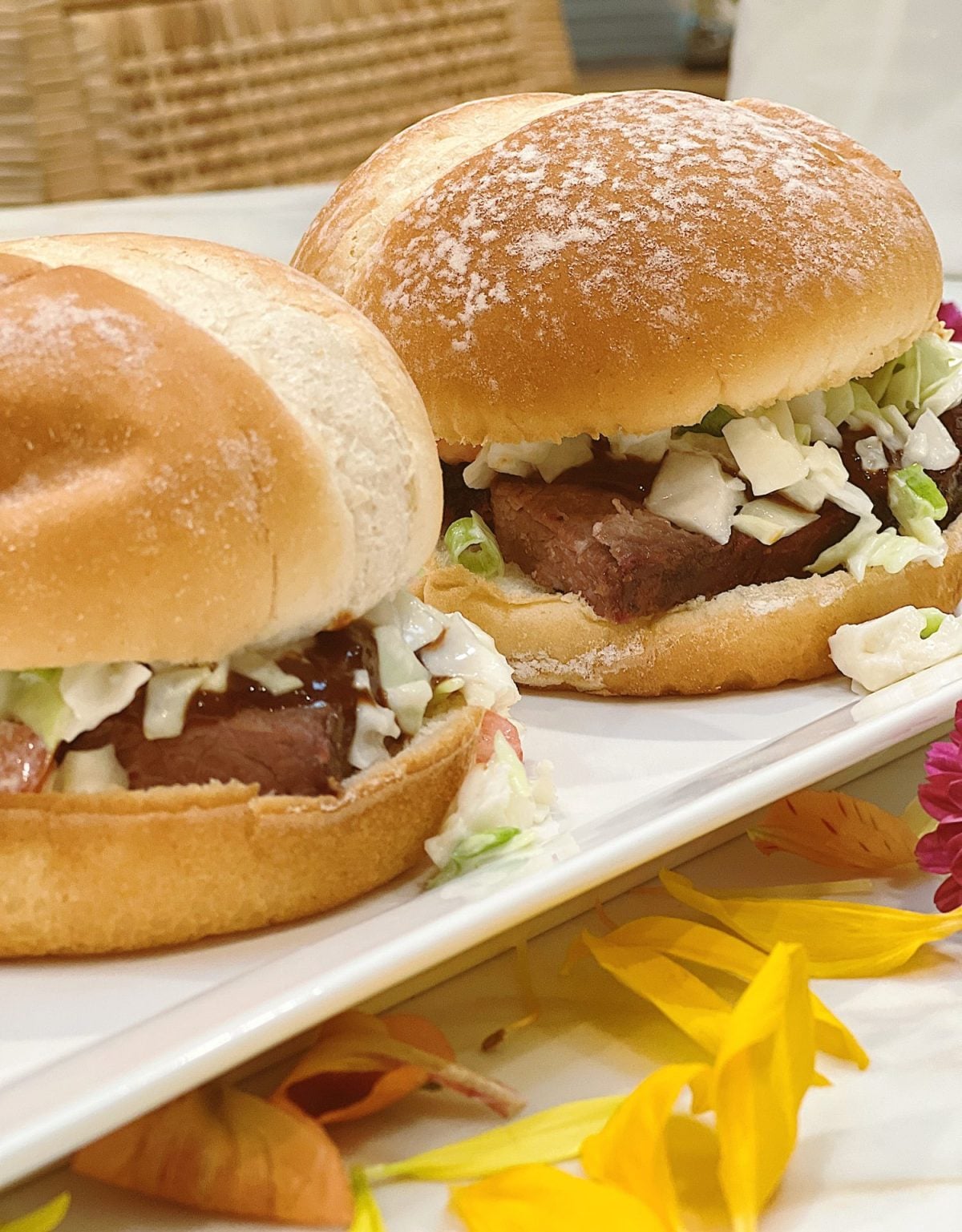 Making smoked brisket sandwiches with barbecue sauce and coleslaw.