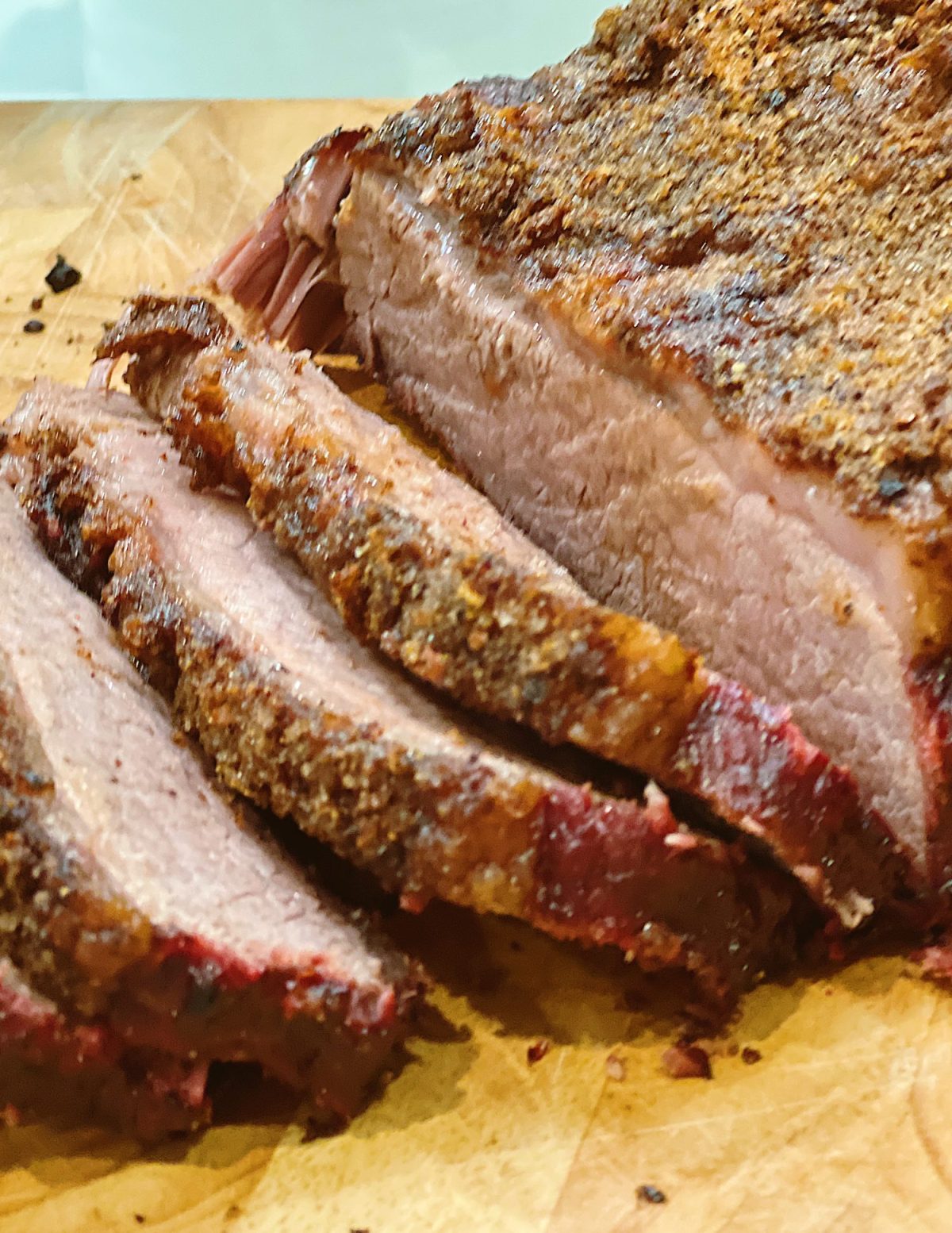 Sliced smoked brisket with a homemade rub.