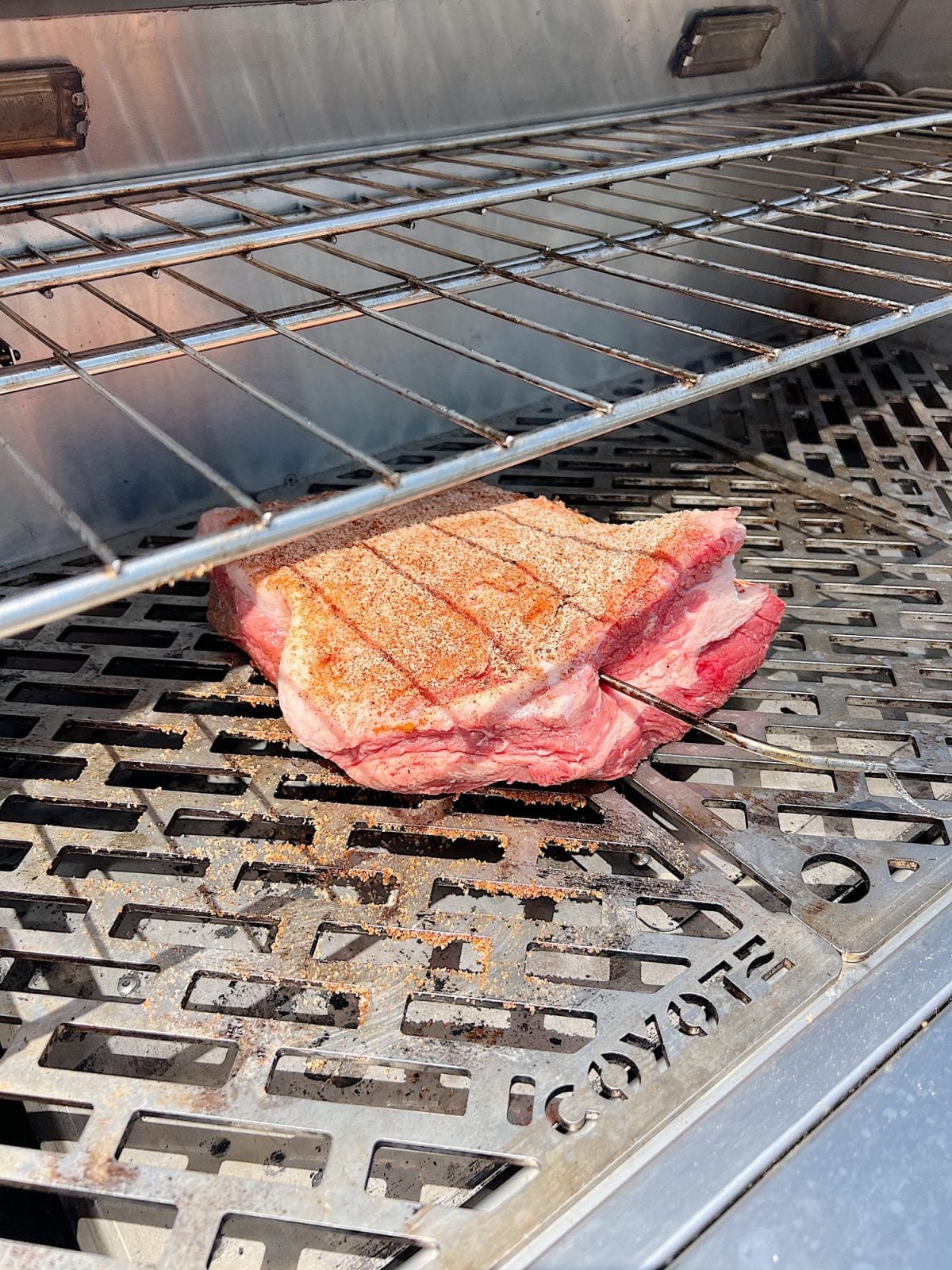Grilling a smoked brisket with a homemade rub.