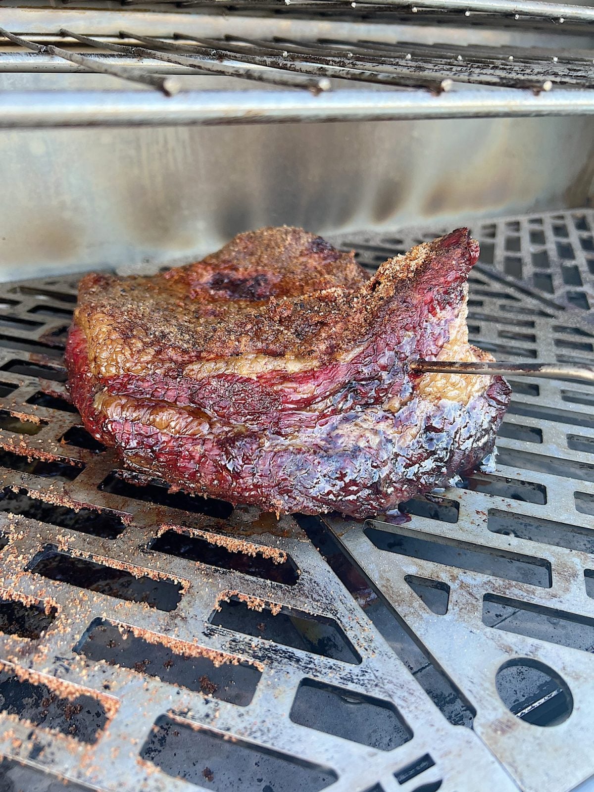 Grilling a smoked brisket with a homemade rub.