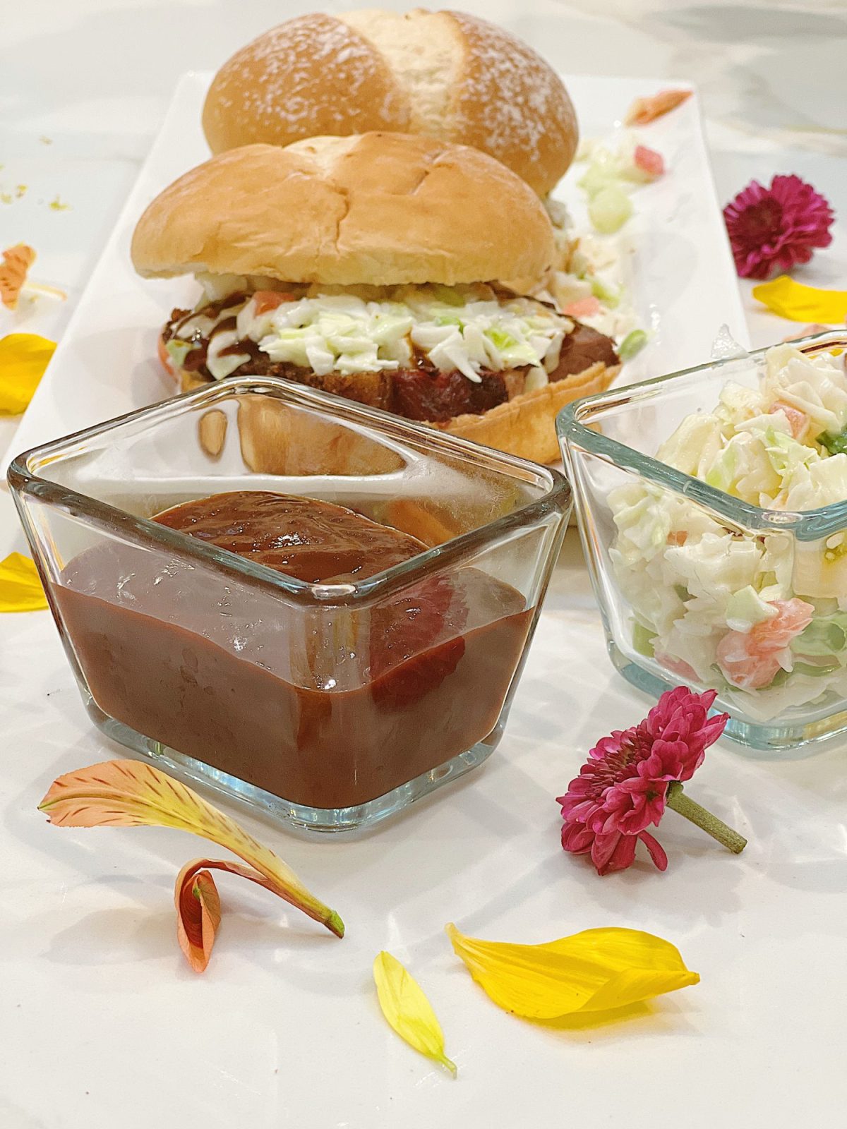 Making smoked brisket sandwiches with barbecue sauce and coleslaw.