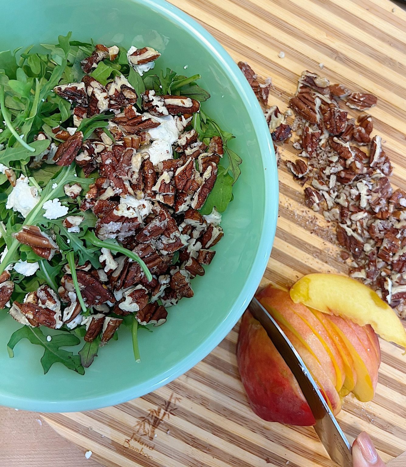 Grilled peach salad with arugula, goat cheese, candied pecans, and a balsamic vinagarette dressing.