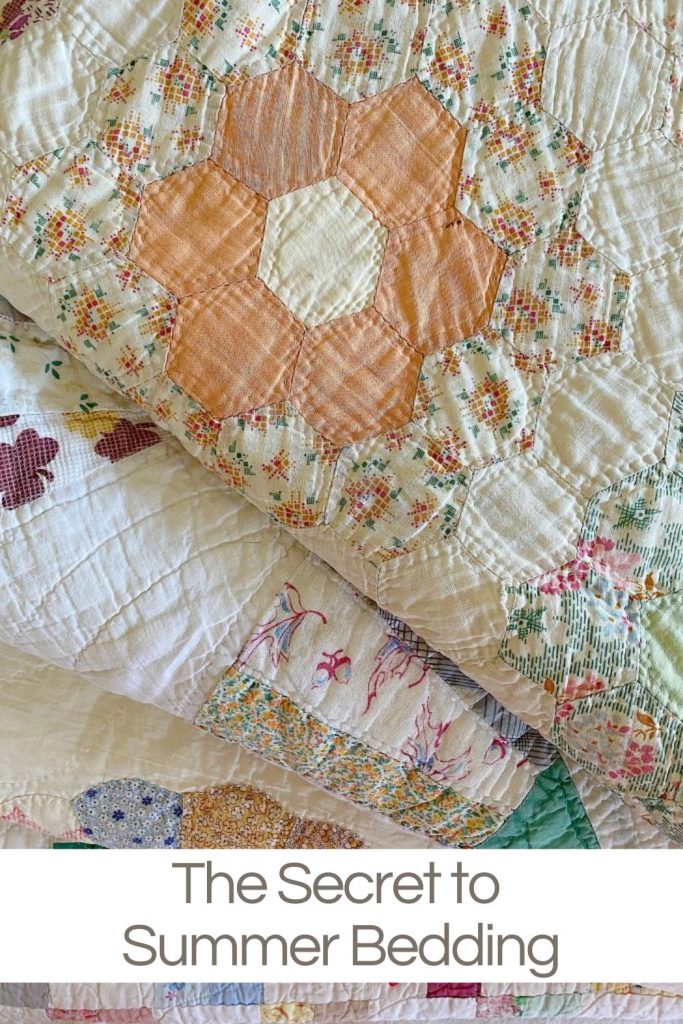 A stack of vintage summer quilts purchased at a flea market.