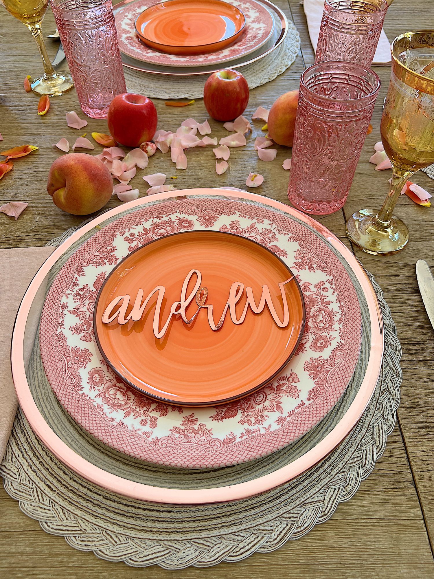 A fall table set in the dining room with pink and copper accents.