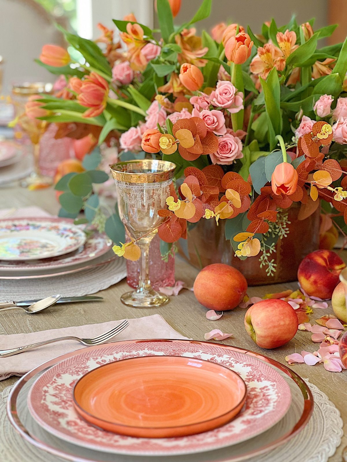 A fall table set in the dining room with pink and copper accents.