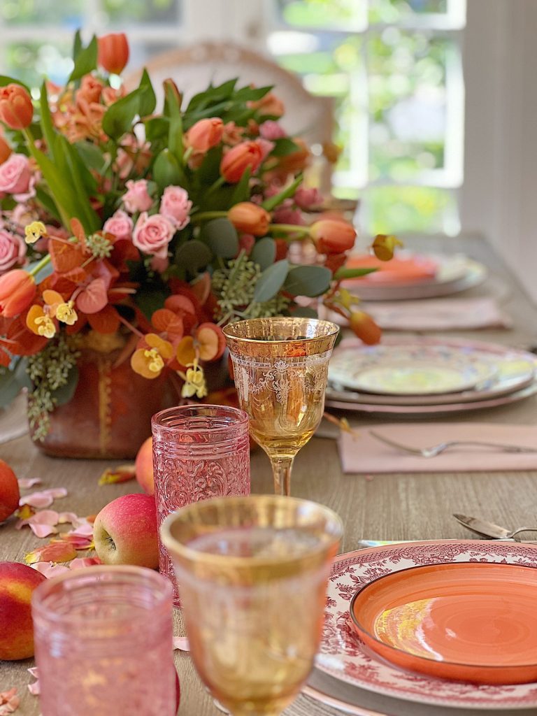 A fall table set in the dining room with pink and copper accents.