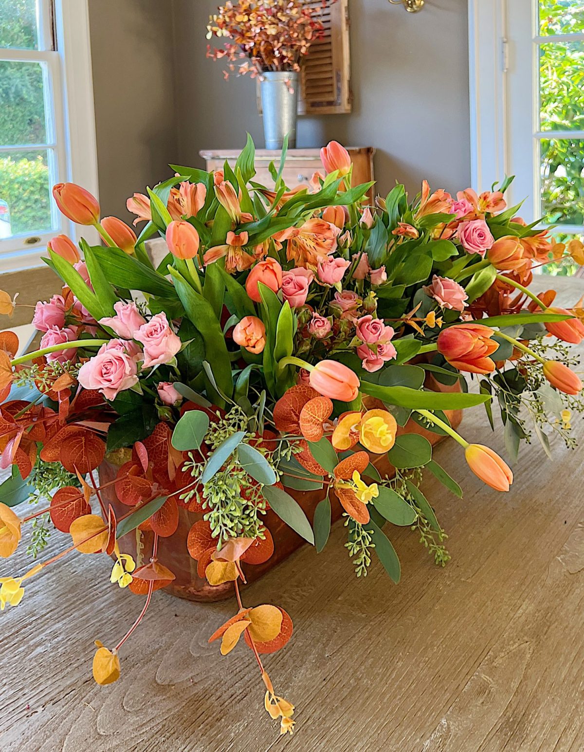 A fall table set in the dining room with pink and copper accents.