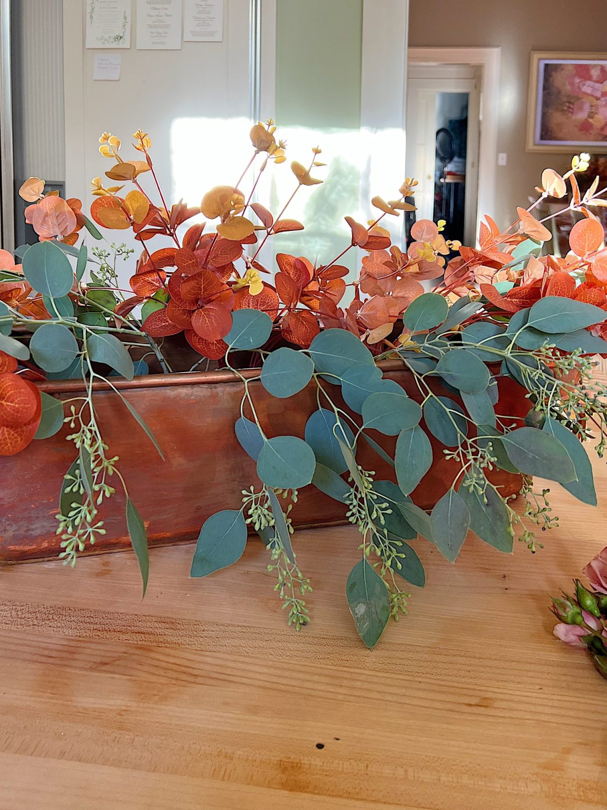 A fall table set in the dining room with pink and copper accents.