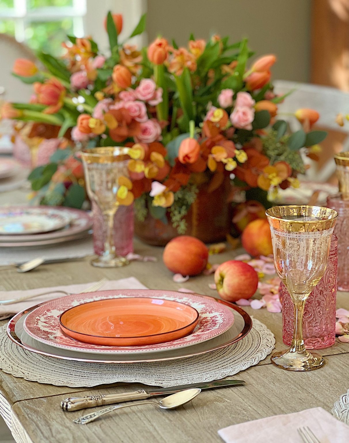 A fall table set in the dining room with pink and copper accents.