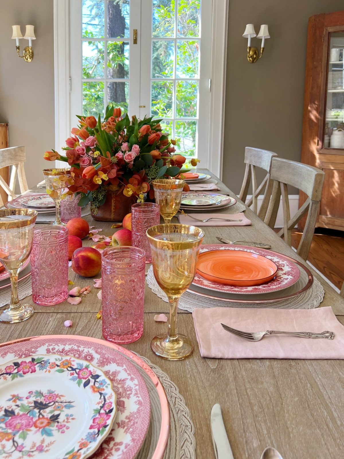 A fall table set in the dining room with pink and copper accents.