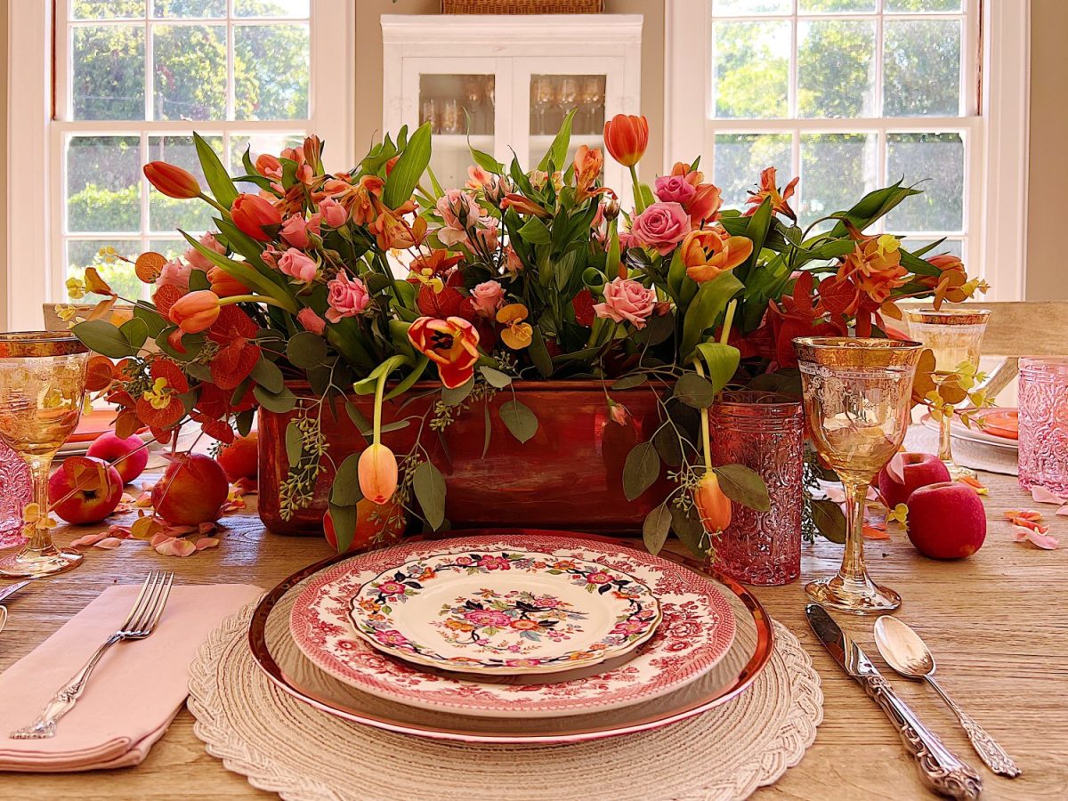 A fall table set in the dining room with pink and copper accents.