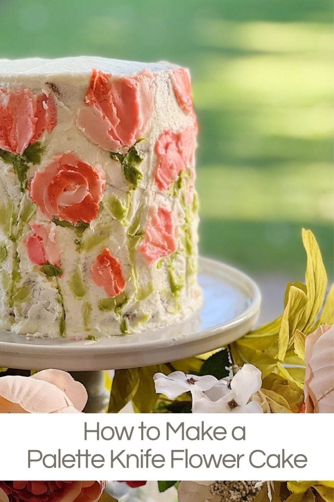 A handmade cake decorated with buttercream frosting flowers using a palette knife.