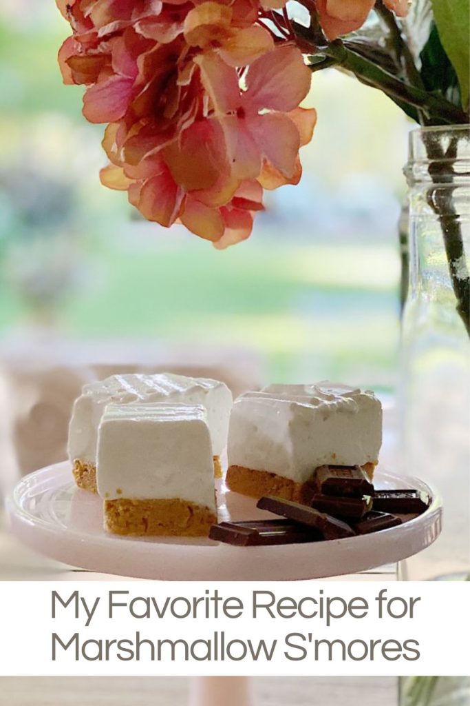 Homemade Marshmallows with a graham cracker crust and chocolates on a cake plate.