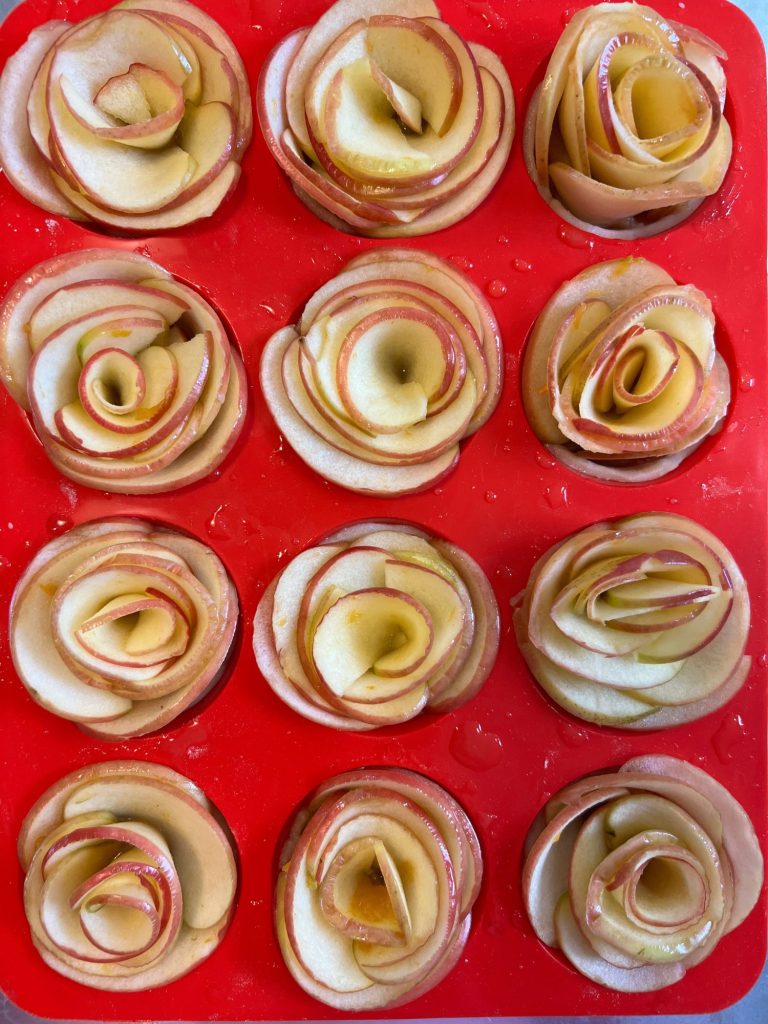 Homemade apple rose tartlets with caramel.