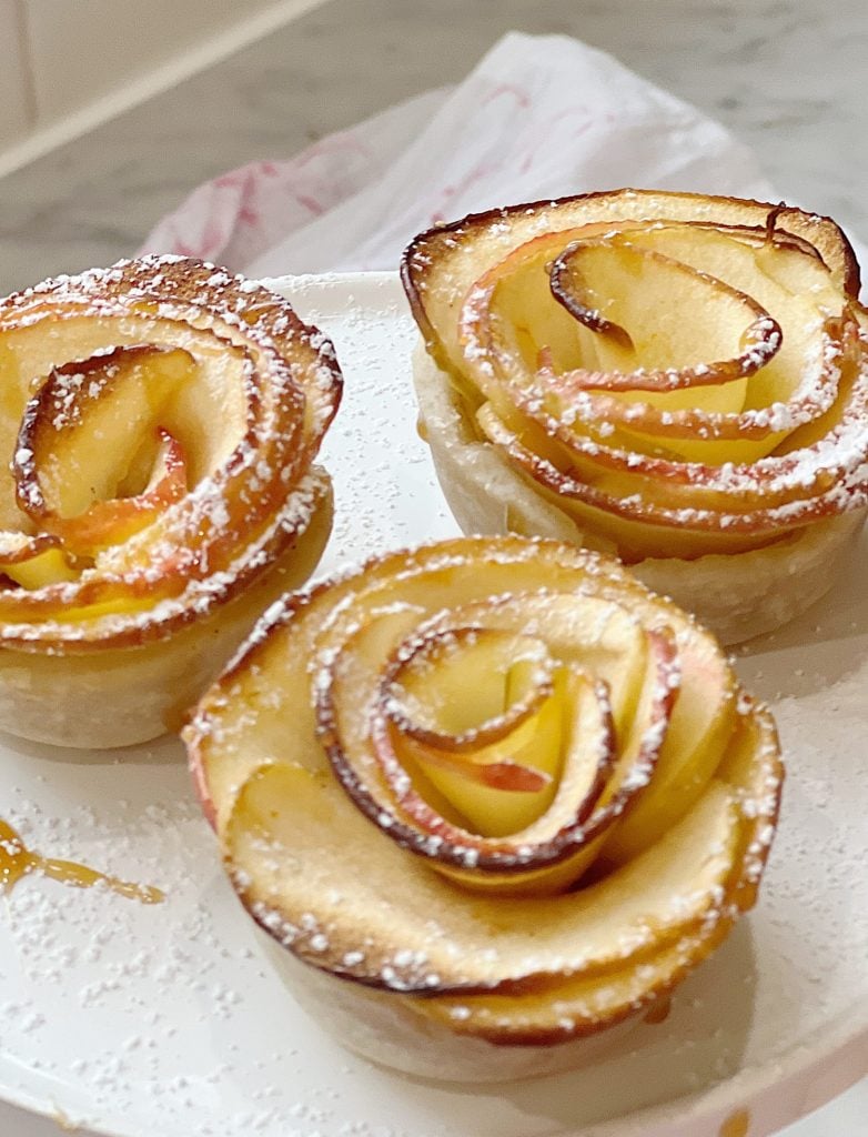 Homemade apple rose tartlets with caramel.