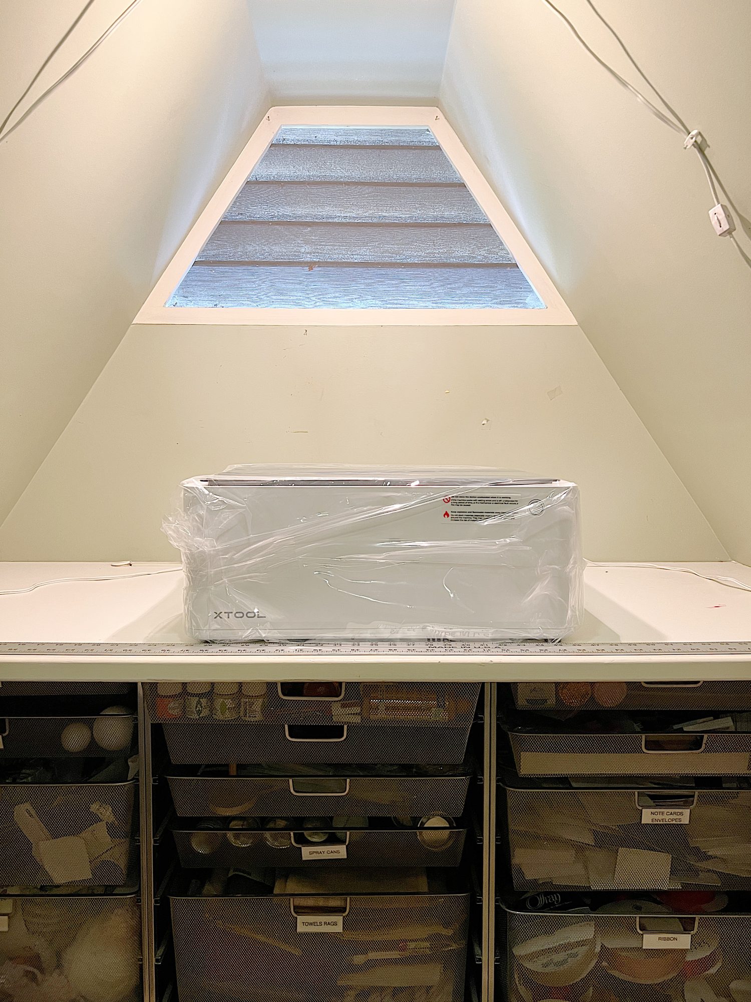 A closet in the eaves of our third floor that stores all of my craft supplies.