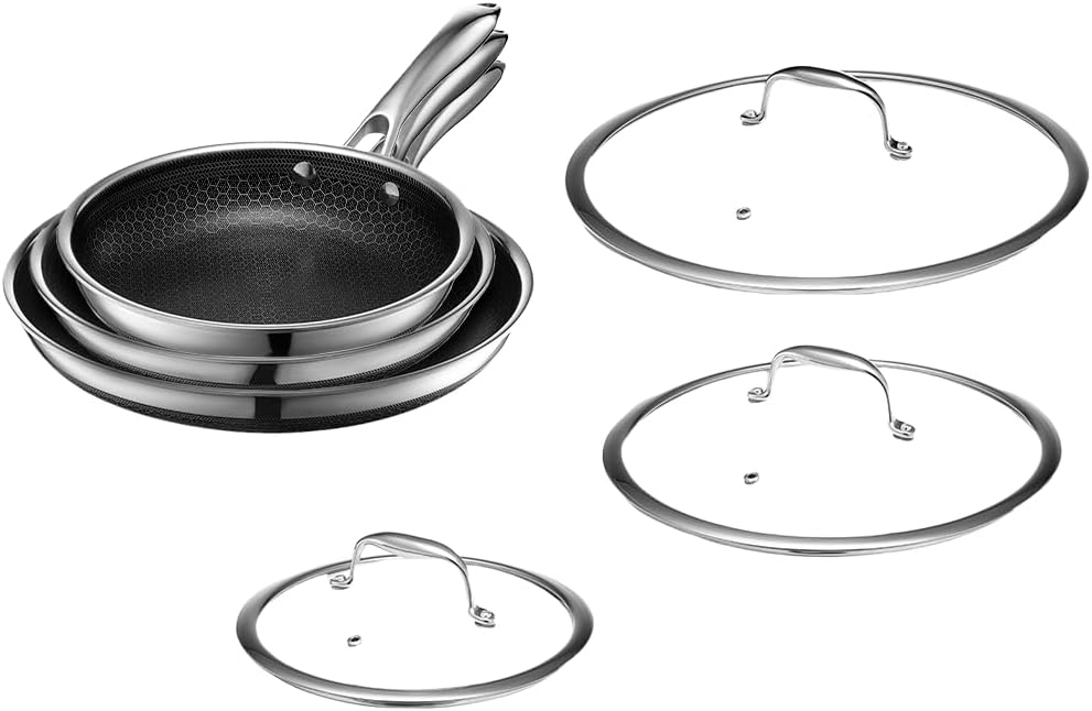 Three stainless steel frying pans stacked together, shown with three matching glass lids placed beside them—perfect for preparing your favorite protein bowl recipes.