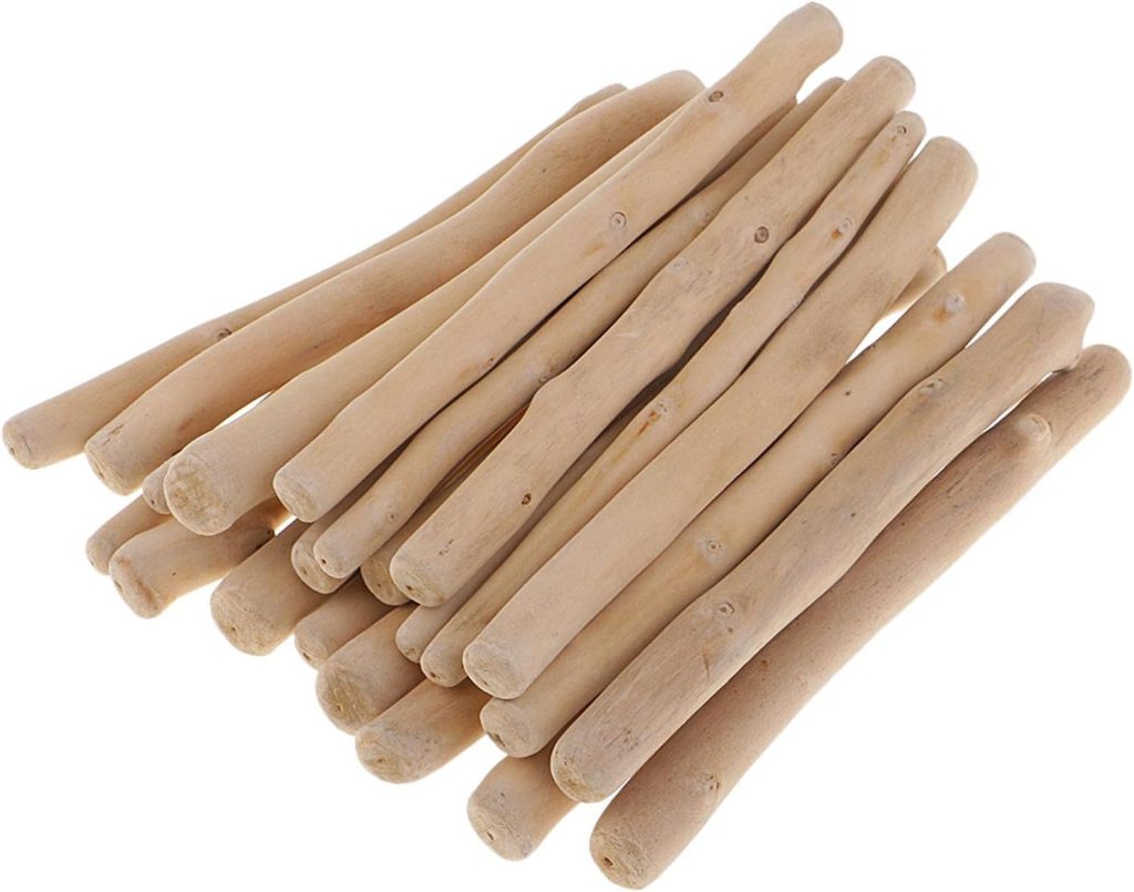 A stack of smooth, light-colored wooden sticks arranged in a pile on a white background, reminiscent of fall pumpkins adorning an autumn display.