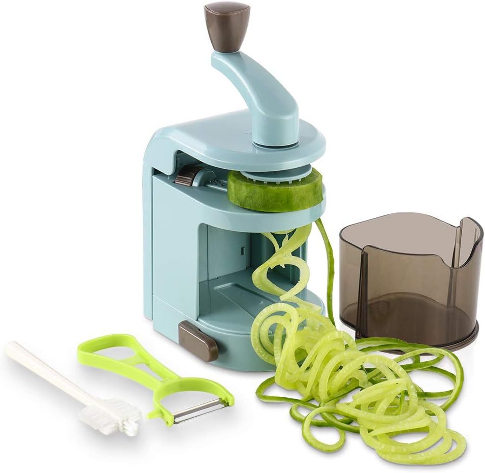 A spiralizer kitchen tool is shown in use, creating green vegetable noodles perfect for a protein bowl. A brush, peeler, and collection container are placed nearby.