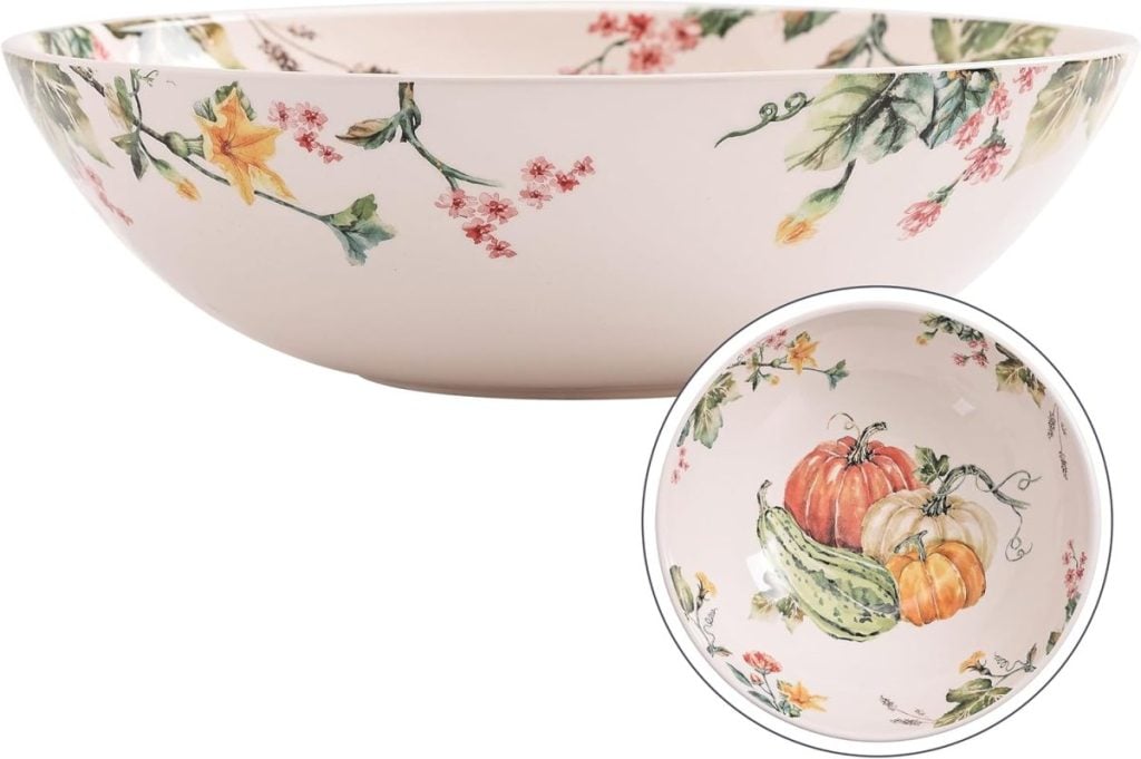 A ceramic bowl with botanical and vegetable illustrations, perfect for serving a Harvest Salad, featuring flowers and leaves on the exterior and pumpkins, gourds, and leaves on the interior.