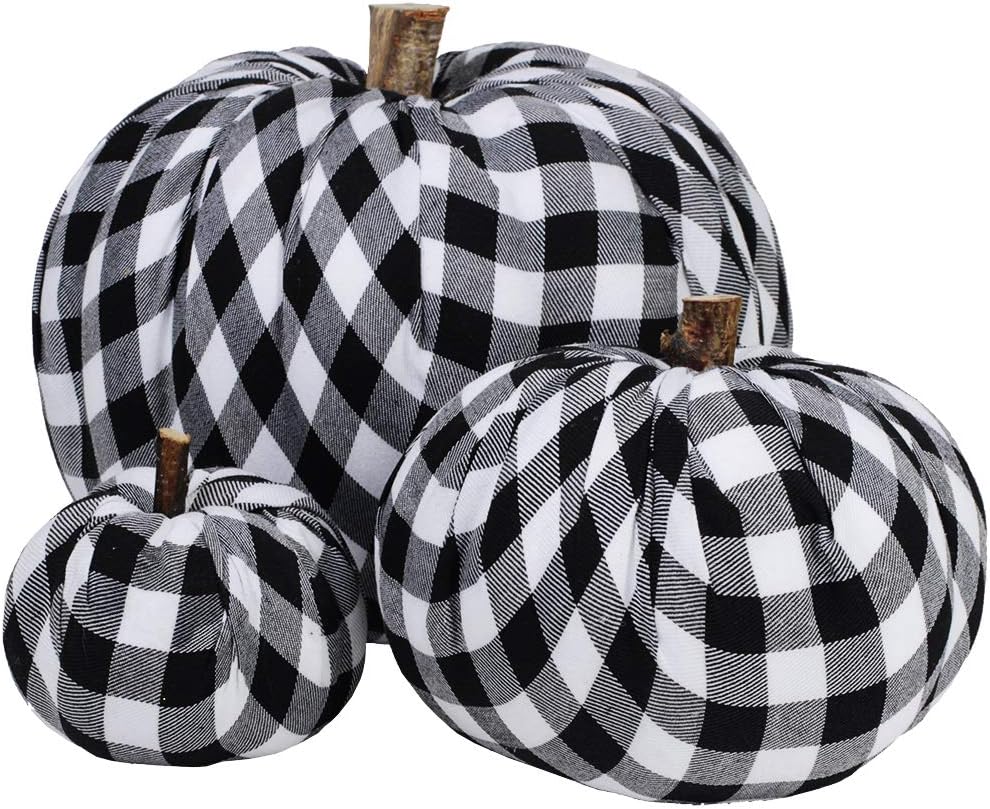 Three black-and-white checked fabric fall pumpkins of varying sizes arranged together.