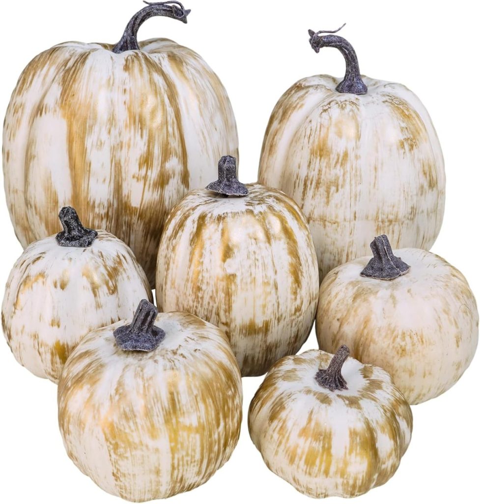 Six fall pumpkins with streaks of brown and dark stems arranged together.