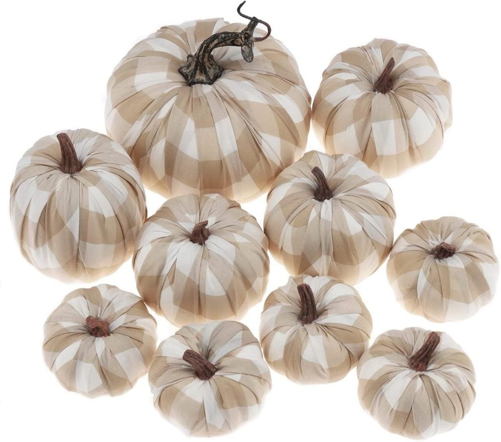 A collection of ten fall pumpkins in beige and white plaid fabric, arranged together in varying sizes.