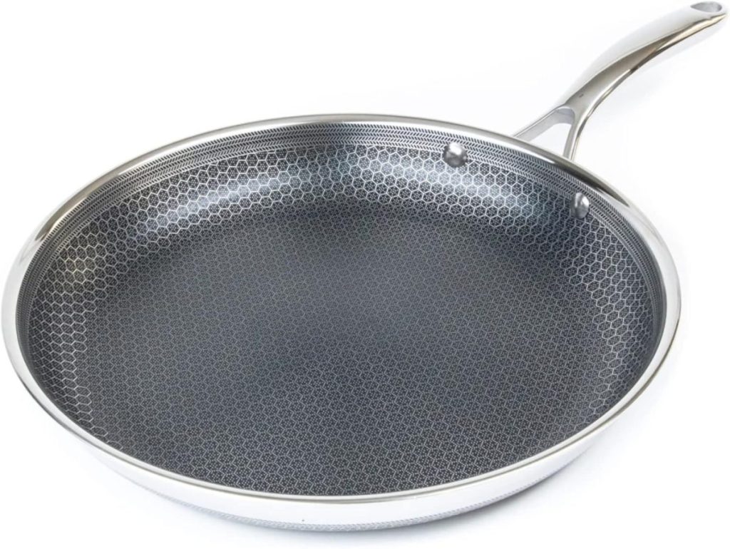 A stainless steel frying pan with a long handle and a honeycomb-patterned nonstick cooking surface, perfect for creating a protein bowl, viewed from above on a white background.