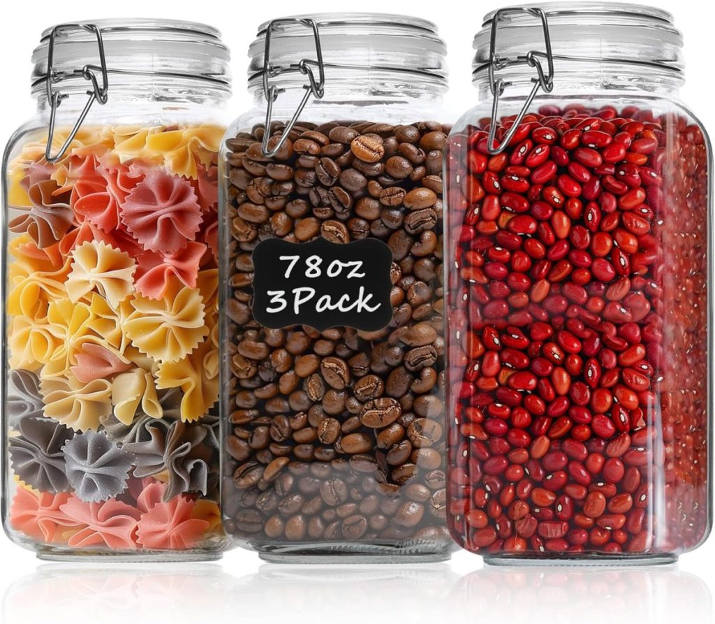 Three clear glass jars with clamp lids containing multicolor pasta, coffee beans, and red beans—perfect for pantry cabinet ideas. The center jar has a label reading "78oz 3 Pack.